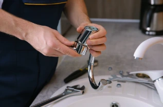 Installation of a new chrome faucet on a bathroom sink